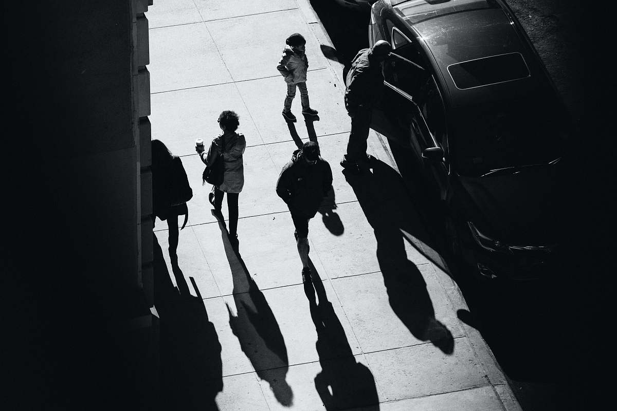 black-and-white grayscale photo of several people walking on pathway grey